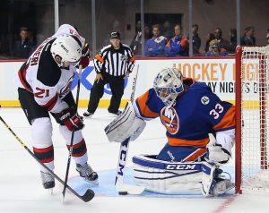 NEW YORK, NY - SEPTEMBER 23: Kyle Palmieri #21 of the New Jersey Devils is stopped in the third period by Christopher Gibson #33 of the New York Islanders at the Barclays Center on September 23, 2015 in the Brooklyn borough of New York City. the Islanders defeated the Devils 2-1. (Photo by Bruce Bennett/Getty Images)