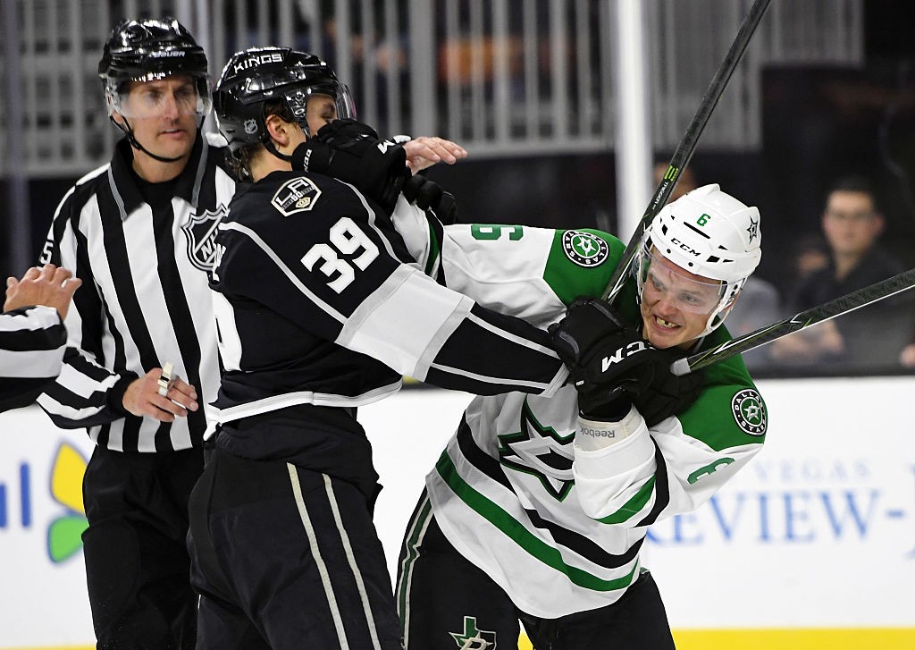 LAS VEGAS, NV - OCTOBER 07:  Adrian Kempe #39 of the Los Angeles Kings and Julius Honka #6 of the Dallas Stars grab each other as referees move in to separate them during their preseason game at T-Mobile Arena on October 7, 2016 in Las Vegas, Nevada. Dallas won 6-3.  (Photo by Ethan Miller/Getty Images)