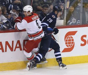 WINNIPEG, MANITOBA - OCTOBER 13: Patrik Laine #29, playing his first NHL game, of the Winnipeg Jets hits Noah Hanifin #5 of the Carolina Hurricanes during NHL action on October 22, 2016 at the MTS Centre in Winnipeg, Manitoba. (Photo by Jason Halstead /Getty Images)